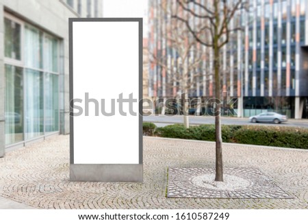 Large blank outdoor billboard with white copy space to add multiple company names and logos with modern office buildings in financial district