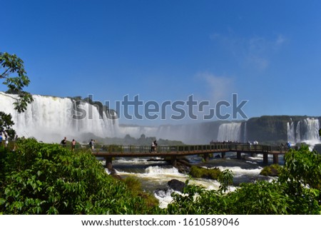 Iguazu falls are easily reached from either side of the Argentine Brazilian border, as well as from nearby Paraguay. Park wildlife includes coatis, jaguars, toucans, walking trails, viewing platforms. Royalty-Free Stock Photo #1610589046
