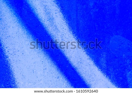 Beautiful bright colorful street art graffiti background. Abstract geometric spray drawing fashion colors on the walls of the city. Urban Culture detailed close up texture neon, white ,blue picture