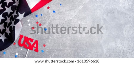 American flag and sign USA on concrete stone background with copy space. Banner template for USA Memorial day, Presidents day, Veterans day, Labor day, or 4th of July celebration. 