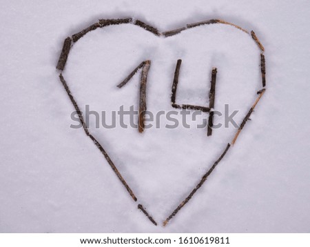 heart in the snow and number 14, laid out of sticks