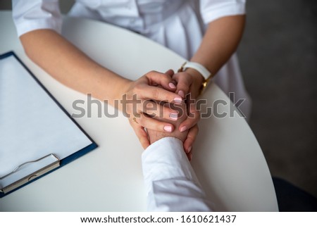 The patient's hand in the doctor's hands. A reassuring gesture. everything will be alright. Good news. Medical diagnosis.