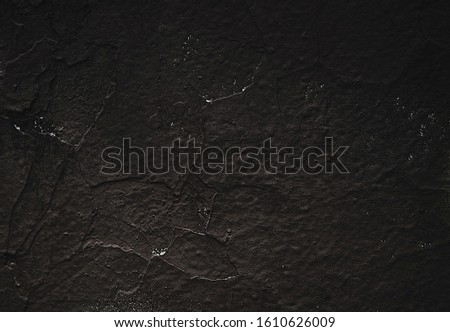 Wall abstraction. Painted surface. Dark Backgrounds. Black stone texture for designers. Abstract Structure. Rock texture. Pile. Stone background. Rough structure mineral. Rock surface with cracks. 