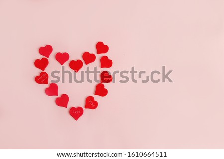Greeting card for Valentine's Day or Women's Day. Red hearts on a pink background, flat lay. Happy holiday, place for text, banner for screen