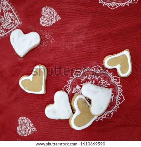 
Homemade heart shaped cookies on a red tablecloth