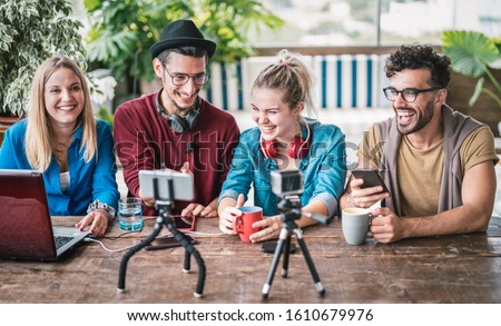 Young friends group sharing info on streaming platform with webcam - Startup marketing concept with millennial guys and girls having fun vlogging live talk feed on social media network - Bright filter Royalty-Free Stock Photo #1610679976