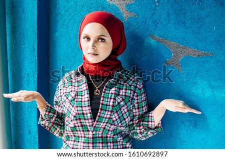 Islamic beautiful woman in a Muslim dress standing on a European street