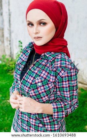 Beautiful young model in fashionable hijab style posing in burnt bush area. Stylish Muslim female hijab fashion lifestyle portraiture concept