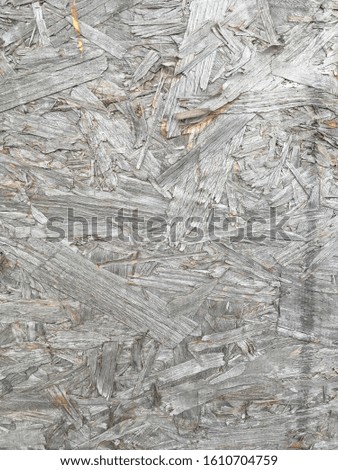 Close up detailed photo of old dry aged compressed wood chip plywood decking panel board flat surface background texture