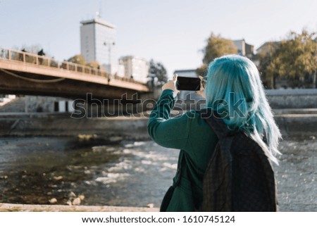 Close-up of woman taking photo with phone