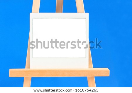 Blank photograph resting on wood easel