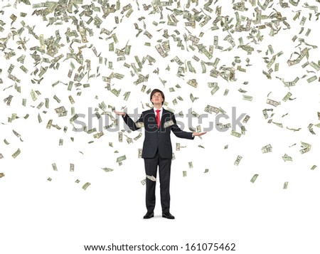 Businessman standing in the rain of money. 1,5,10,20,50,100 dollar bills