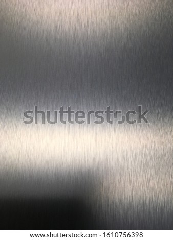 Close up vertical detailed color photo of decorative industrial brushed metal shiny background textured background