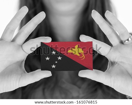 Woman showing a business card, black and white, Papua New Guinea