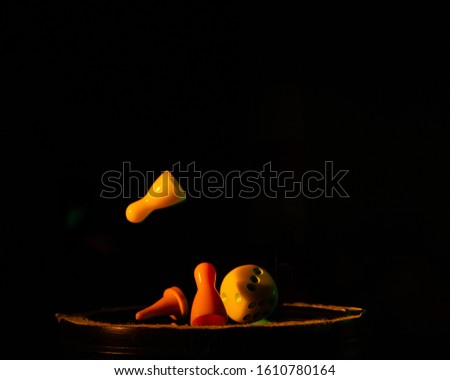 dice and chips on a black background illuminated by a small beam of light