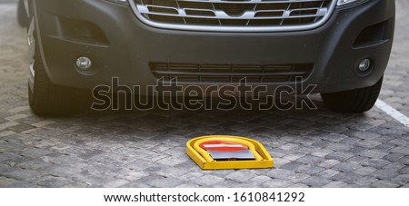 Manual car parking barrier with lock and stop sign. Car parking lock device. Dedicated parking for guests. Traffic rules, prohibitory signs