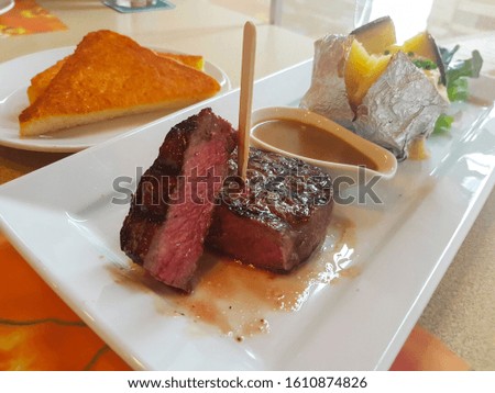 Medium beef steak in a meal set Royalty-Free Stock Photo #1610874826