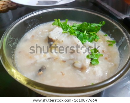 Porridge with sea bass fish in glass cup Royalty-Free Stock Photo #1610877664
