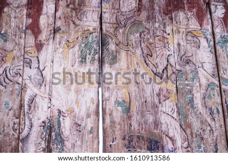 Ancient Thai picture on the wooden wall.
