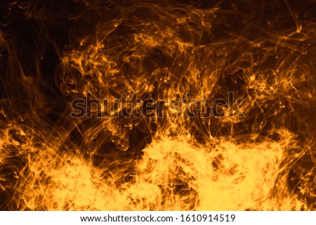 Creative abstract photo with pseudo burning fire effect. Dissipating in water ink colored with vibrant yellow color.