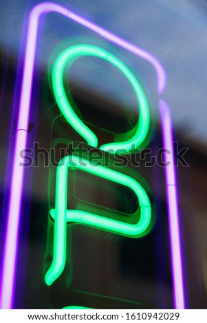 Green and purple, neon open sign