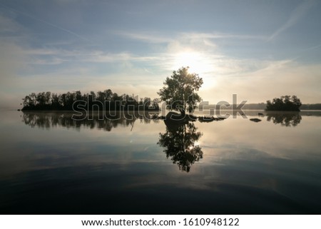 tranquil lake view with small wooded islands