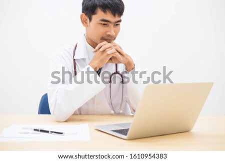 Young doctor working in his office stock photo