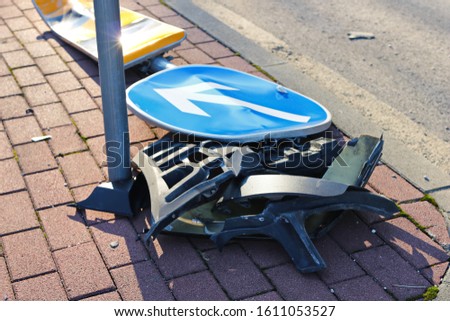 Demolished traffic sign after a car accident in which a car sped off the roadway and hit a traffic sign