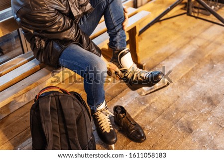 Man is putting on his skates. Hobbies, sports, vacations and winter activities. Selective focus. Close-up