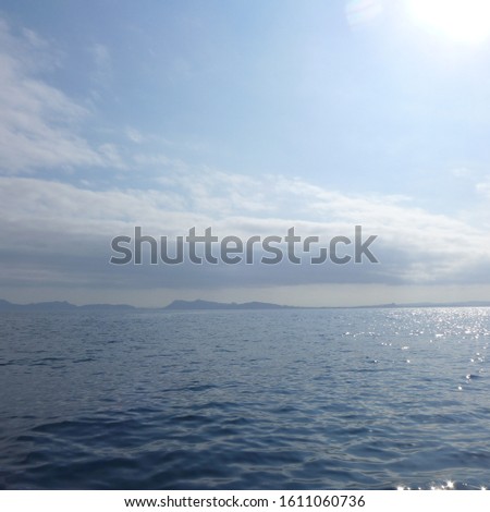 A nature photo of the ocean and the sky with unusually soft tones