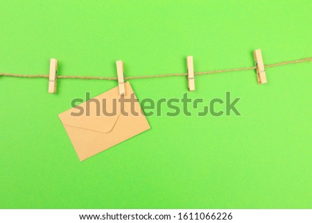 envelopes hanging on a clothesline with green background