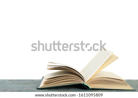 Open old hardcover book on wooden table