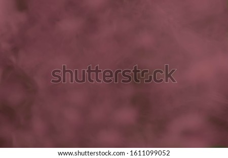 Blurred dark red marbled background with space for text or copy