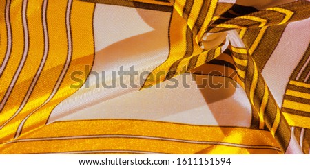 Texture, background, silk fabric with a yellow striped pattern. The design of this fabric is dedicated to a white rabbit mosaic representing the look of a fabulous vest.