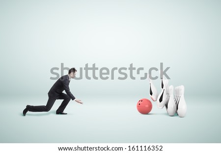 businessman in suit playing bowling