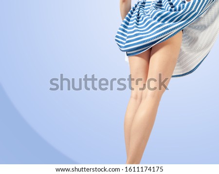 A girl in a striped dress, nautical theme; vest; coloring of the dress; the wind lifted the hem; black panties are visible;