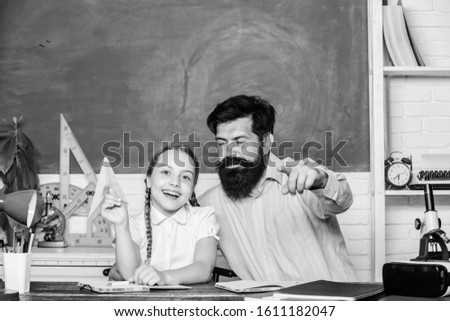 Good news. daughter study with father. Teachers day. knowledge day. Home schooling. small girl child with bearded teacher man in classroom. back to school. Private teaching. private lesson.