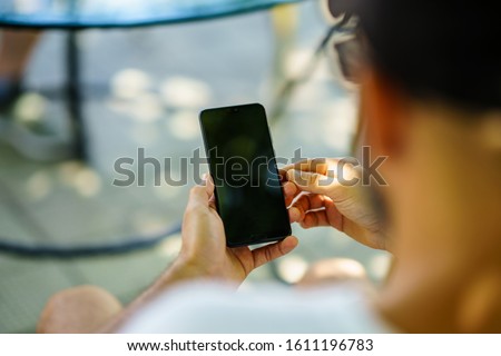 Man using smartphone. Male hand holding smartphone