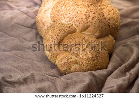 wicker white bread with sesame seeds on a decorative background