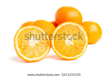 Sliced round halves of orange fruit and whole citrus isolated on white background.