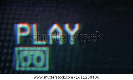 An old damaged VHS tape playing, over noise from an analog TV, with a PLAY text. Cool retro vintage background for modern videos. playing old vhs on vcr  Royalty-Free Stock Photo #1611258136