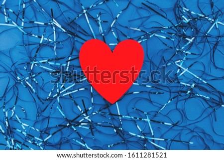 Red hearts on a classic blue background. Film blue background. Valentine day. Minimal love concept. Copy space for your text. Flat lay style. Top view. 