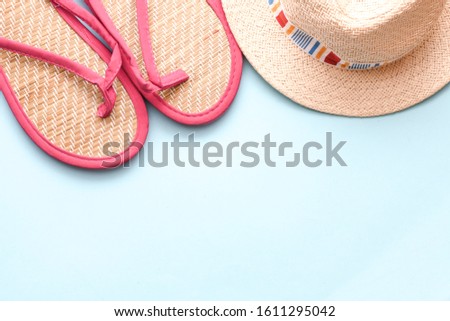 Beach accessories on a blue background. Time for summer vacation. Free space to add text or graphics.