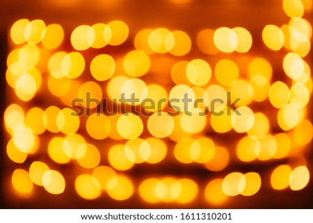 Christmas background. Festive golden abstract background with bokeh defocused lights and stars