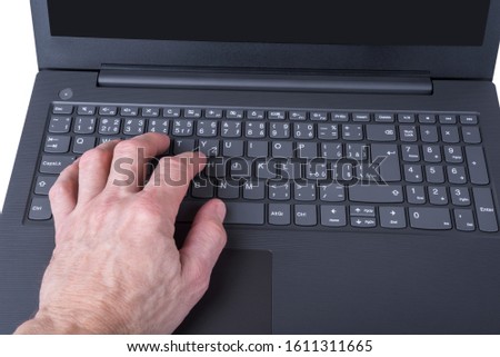 Modern slim laptop with keyboard detail with hand
