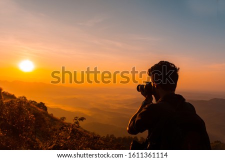 Photographer taking photos of mountains scenery during the sunrise ,beautiful landscape scenery shot from Palakkayam Thattu Kannur, Kerala Travel and Tourism Concept Image, Nature Photography Day