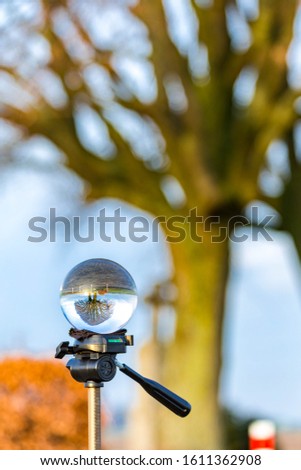 Glass ball pictures in nature with tree, windmill, sunset and field.