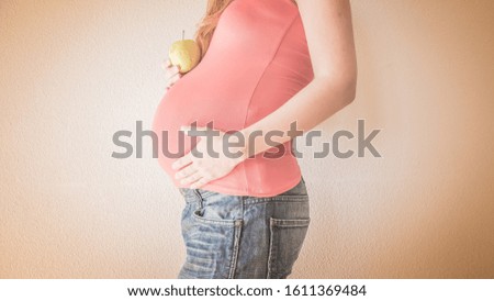 Pregnant woman's belly close up. Concept of a new life, expectations and hope.
