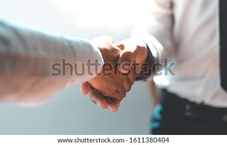 Men and women negotiate to congratulate a successful business ,Shaking hands concept.