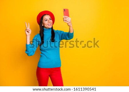 Portrait of her she nice attractive lovely cheerful cheery girl making taking selfie having fun  showing v-sign enjoying trip weekend isolated over bright vivid shine vibrant yellow color background